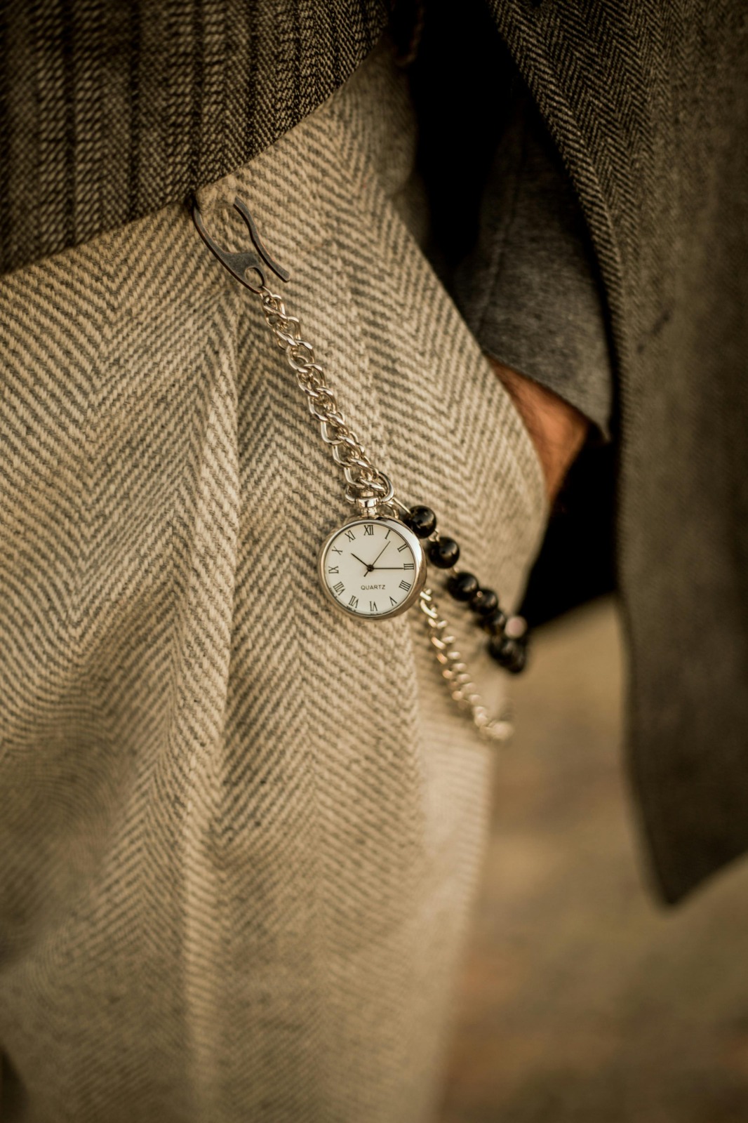 Herringbone wool trouser with a silver pocket watch on a chain